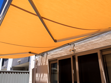 Orange folding arm awnings