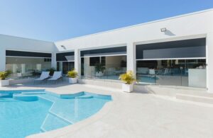 Motorized blinds used to separate home with outside pool area