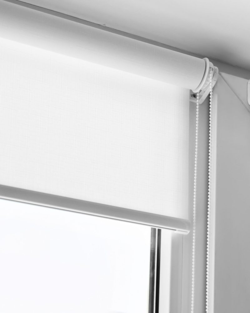 White,Roller,Blind,On,A,Metal,Plastic,Window